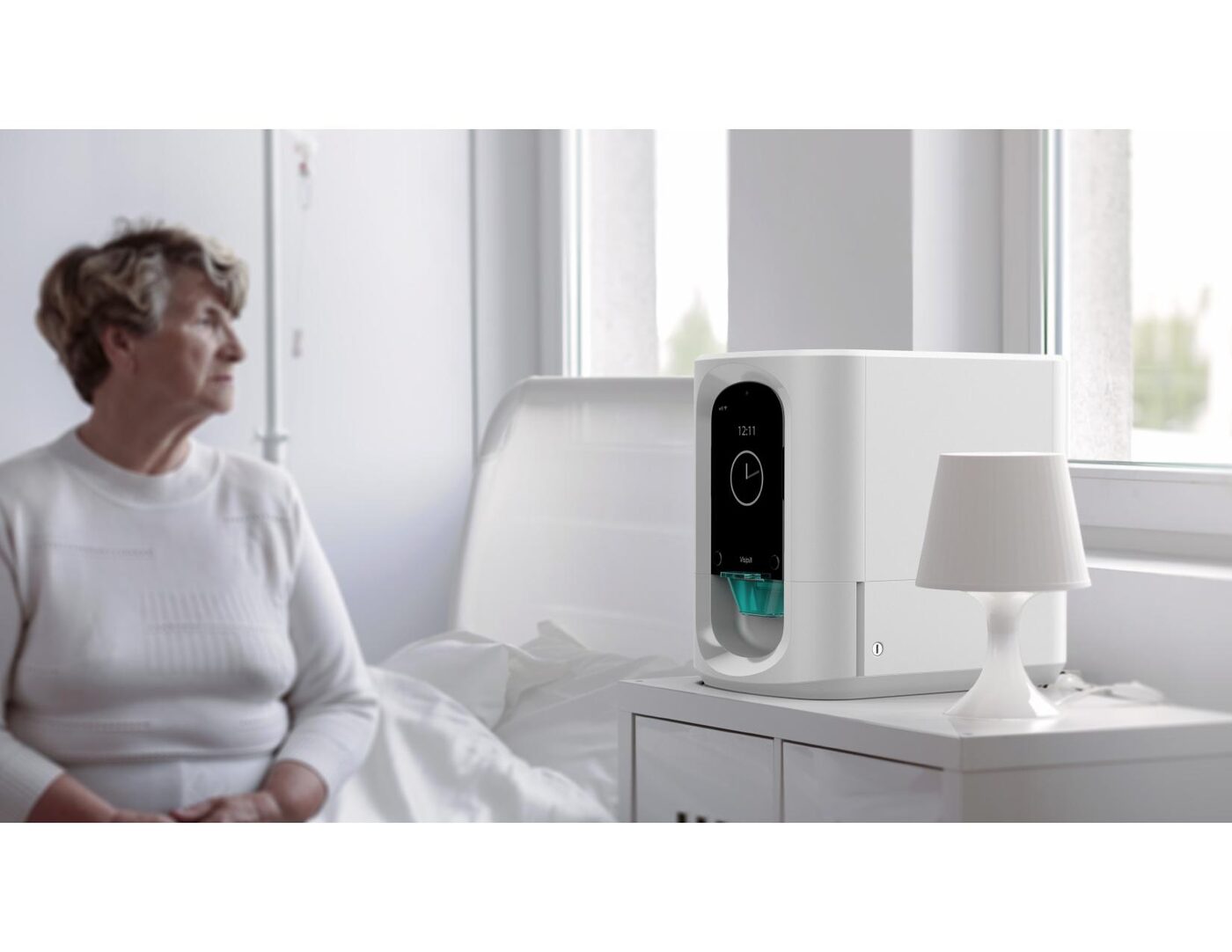 An older adult beside a Visipill on the nightstand